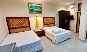 a room with two beds in a room at Goa Ganesha in Nusa Dua