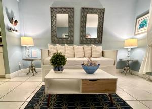 a living room with a couch and two mirrors at Suite Love in Miami Beach