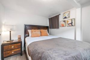 a bedroom with a bed and a night stand with a lamp at Hot Tub Haven+.4 mi. USU East+1G in Price