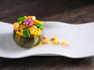 a stuffed acorn squash with corn and vegetables on a fork at Ogiwarakan in Chikuma