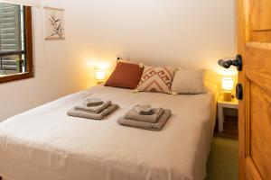 a bedroom with a bed with towels on it at Holiday house with a parking space Priselci, Karlovac - 21949 in Karlovac