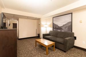 a living room with a couch and a coffee table at Super 8 by Wyndham Prince George in Prince George