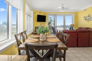 a dining room with a table with chairs and a couch at 3 BR Belmont Towers on Boardwalk: Ocean & Bay Views in Ocean City