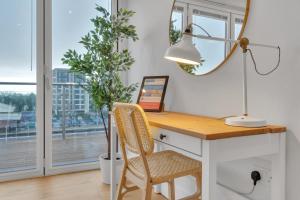 a desk with a lamp and a plant in a room with a window at Station Skyline One By My Getaways in Brighton & Hove