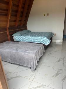 A bed or beds in a room at Pousada Pedra Cantante