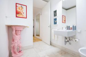a bathroom with a pink statue on the wall at Boutique Apartment in the Heart of Lisbon ! Lemonn B in Lisbon