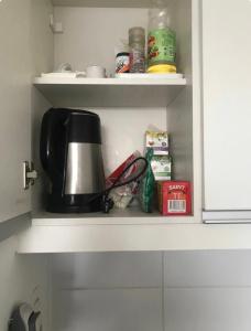 a cupboard with a coffee maker and other kitchen items at Studio Park in Montevideo