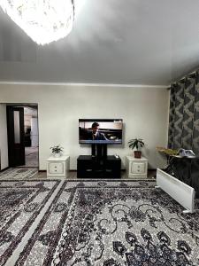 a living room with a flat screen tv on a wall at Balu in Karakol