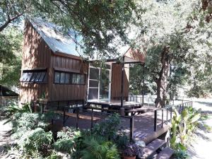 a wooden house with a picnic table in a garden at Khum Charoen Homestay 