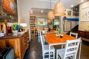 a dining room with a wooden table and white chairs at Casa de Arte CiTá, bed and breakfasts in San Miguel de Tucumán