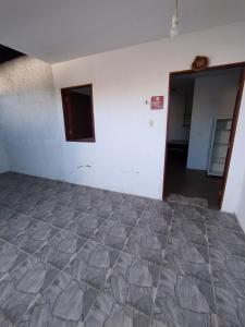 an empty room with a hallway and a door at Flat Tamandaré in Tamandaré