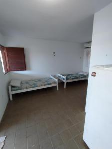 a room with two bunk beds and a refrigerator at Flat Tamandaré in Tamandaré