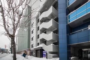 a building with snow on the side of it at ASPEN【2min from Asahikawa sta】 in Asahikawa