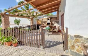 a wooden gate to a patio with a fence at Nice Home In Barbate With Wi-fi in Barbate