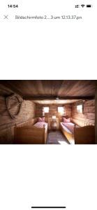 a room with two beds in a wooden building at Alphotel & Bergrestaurant Sankt Martin 