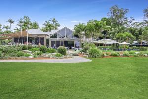 a house with a lawn in front of it at Oceanique in Coffs Harbour