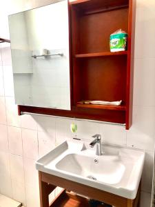 a white sink in a bathroom with a mirror at Meet sunset hostel Luangprabang in Luang Prabang