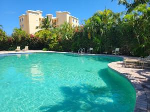 a swimming pool with blue water in front of a building at Gated waterfront condo with boat dock and view in Freeport