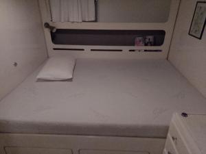 a small kitchen with a white counter top in an rv at Barba Rude in Punat
