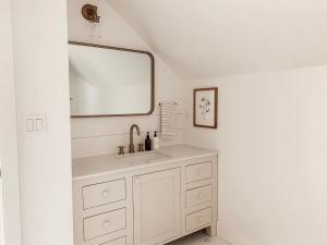 uma casa de banho com um lavatório e um espelho em Homestead Barn Loft em Sonora