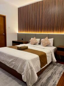 a bedroom with a large bed with white sheets at The Kayuri in Canggu