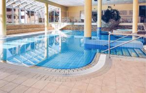 a large swimming pool in a building at Amazing Apartment In Pohorje With House A Panoramic View in Hočko Pohorje