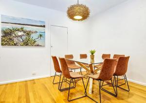a dining room with a table and chairs at Beached in Sawtell