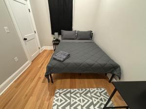 a small bedroom with a bed and a rug at 3 HOMESTAY At Boston In Dorchester or JFK-UMASS or South Boston in Boston