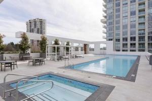 a large swimming pool on top of a building at Luxury Oceanfront 1BR condo at Lions Gate in North Vancouver