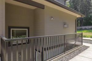 a balcony of a house with a door on it at Bright new 1 BR private secondary basement suite in North Vancouver