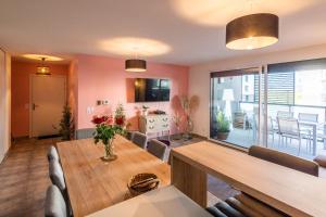 a living room with a wooden table and a dining room at AQUARELLES - Modern and spacious in Annecy