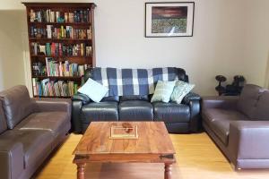 a living room with two couches and a coffee table at The Bower in Kalorama
