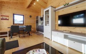 a living room with a large flat screen tv in a cabin at Awesome Home In Merzalben With Wi-fi in Merzalben