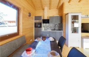 a dining room with a table and a kitchen at Awesome Home In Merzalben With Wi-fi in Merzalben