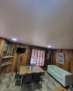 a living room with a table and a couch at Cabañas Condominio El Bosque in Pucón