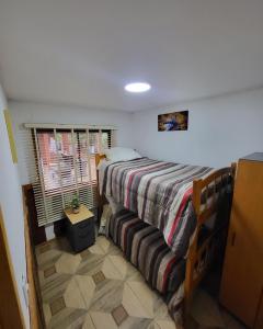 a bedroom with a bed and a window at Cabañas Condominio El Bosque in Pucón