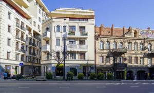 a group of buildings on the side of a street at Hotel type rooms on avenue Melikishvili, city center in Tbilisi City