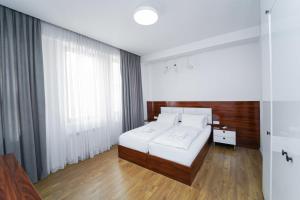 a bedroom with a white bed and a window at Hotel type rooms on avenue Melikishvili, city center in Tbilisi City