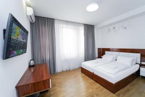 a hotel room with a bed and a television at Hotel type rooms on avenue Melikishvili, city center in Tbilisi City