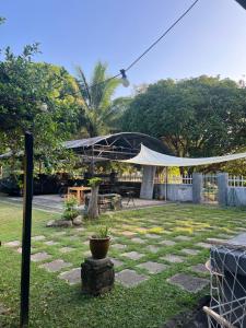 a patio with a tent in a yard with a table at RUMAH SANTAI in Sungai Petani