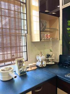 a kitchen counter with a blue counter top at RUMAH SANTAI in Sungai Petani +24 photos