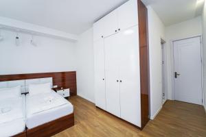 a bedroom with a white bed and a large mirror at Hotel type rooms on avenue Melikishvili, city center in Tbilisi City