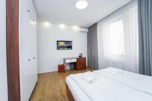 a hotel room with two beds and a television at Hotel type rooms on avenue Melikishvili, city center in Tbilisi City
