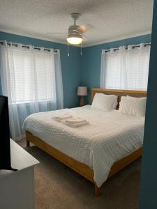 a bedroom with a large bed with blue walls at Beach Please* in Carolina Beach