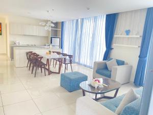 a living room and kitchen with a table and chairs at Maldives B3-30 Oceanami Villas & Beach Club in Long Hai