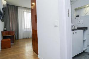 a room with a kitchen and a living room at Hotel type rooms on avenue Melikishvili, city center in Tbilisi City