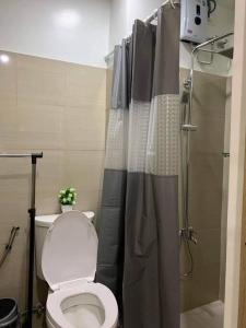 a bathroom with a toilet and a shower at Shore Residence D22 shortwalk MOA Balconypoolview in Manila