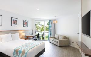 a hotel room with a bed and a desk and a chair at Holiday Inn Suva by IHG in Suva