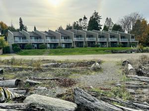 a large apartment building with a lot of windows at Beachfront Walkout Condo in Qualicum Beach