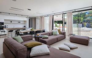 a living room with two couches and a kitchen at Villa Amber in Pakoštane